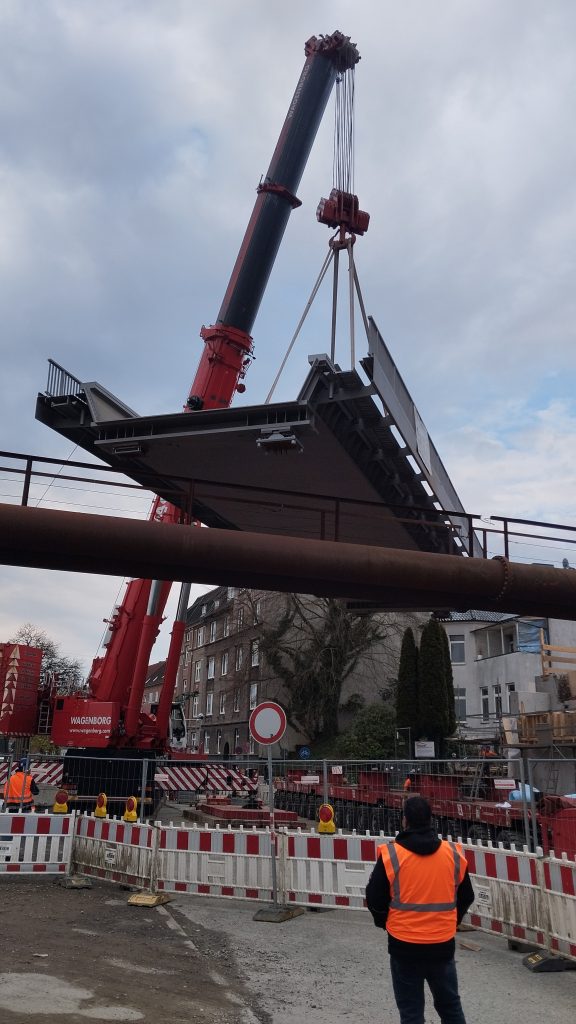 Mobilkran hebt den 138 Tonnen schweren Stahlüberbau auf die Widerlager der EÜ Alte Lübecker Chaussee in Kiel